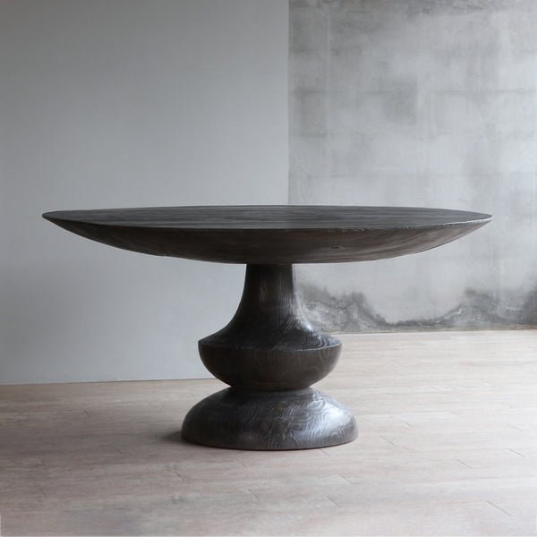 Bali Dining Table's front view. A circle dining table with single turned leg. It was made from reclaimed pine wood.