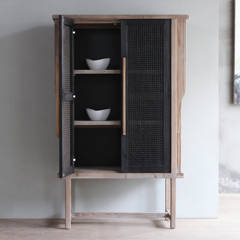 Front view of LUNAR Rattan Tall Cabinet with one door opened. There are white bowls inside.