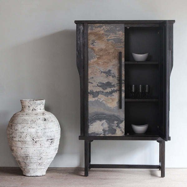 LUNAR Stone Tall Cabinet next to a white vase with one door opened.