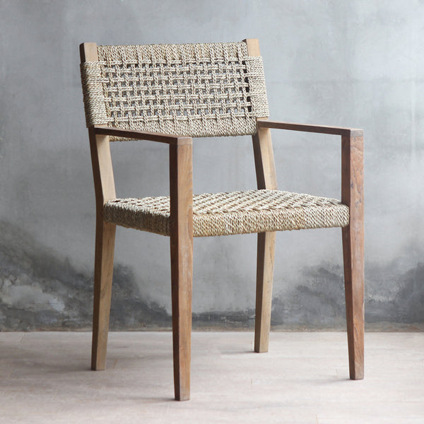 3/4 view of LYON Armchair. Made from reclaimed teak wood frame and woven sisal backrest and seat.