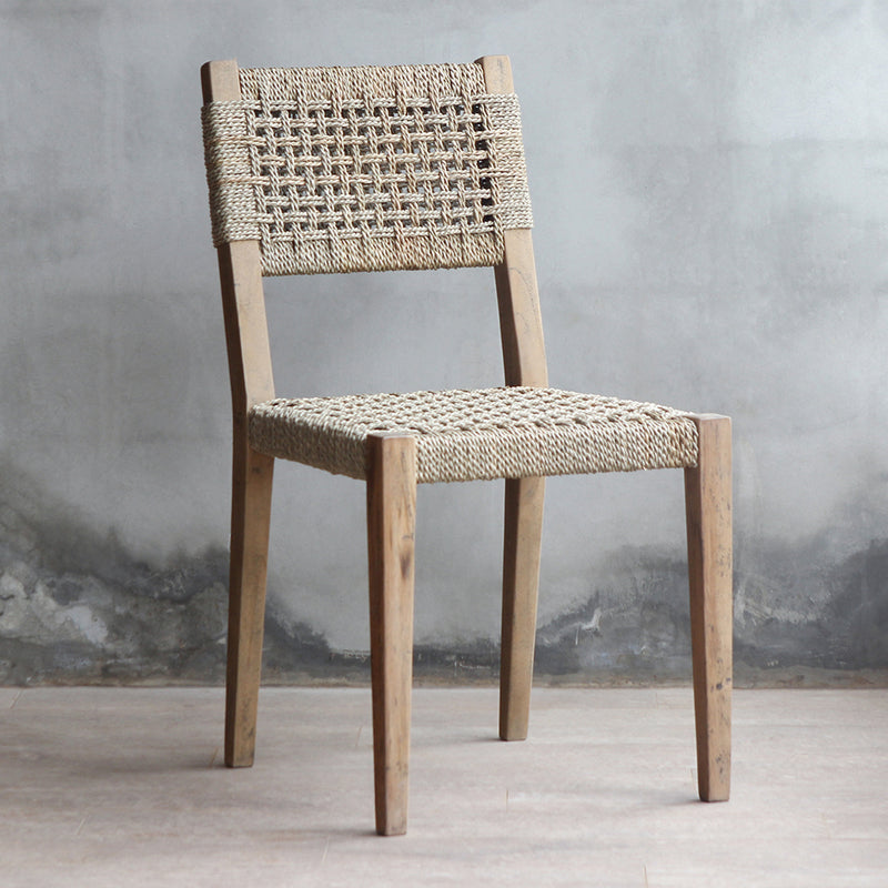 3/4 view of LYON Chair. Made from reclaimed teak wood frame combined with woven sisal backrest and seat.