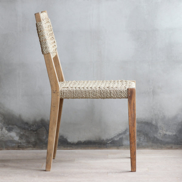 Side view of LYON Chair. Made from reclaimed teak wood frame combined with woven sisal backrest and seat.