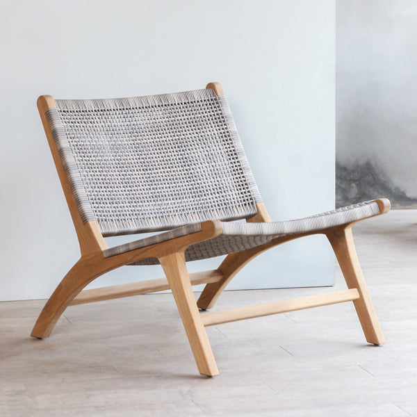 Perspective view of Lovina Lounge Chair. Made from reclaimed teak frame and synthetic rattan weaving.