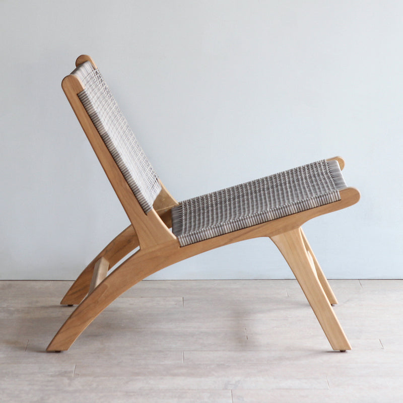 Side view of Lovina Lounge Chair. Made from reclaimed teak frame and synthetic rattan weaving.