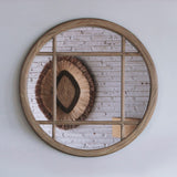 Round wooden mirror on a white wall