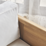 Outdoor wooden sofa with white cushion