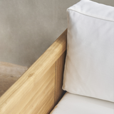 Outdoor wooden sofa with white cushion