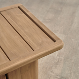 Outdoor wooden end table on a wooden floor