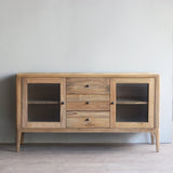 Wooden sideboard with glass doors in a minimalistic room
