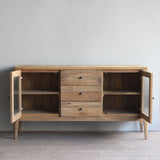 Wooden sideboard with open doors in a minimalistic room.
