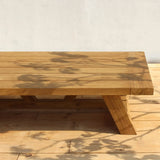 Wooden coffee table on a wooden floor with a neutral background