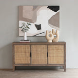 Reclaimed pine wood sideboard with rattan doors in a room with abstract art on the wall.
