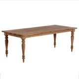 Wooden dining table with turned legs on a white background