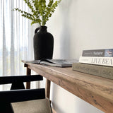 Live edge top table detail of Vanity Console with books and potted plant on top of it.