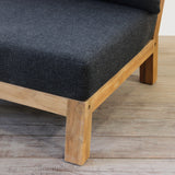 Outdoor sofa with dark gray cushion and wooden frame on a wooden floor