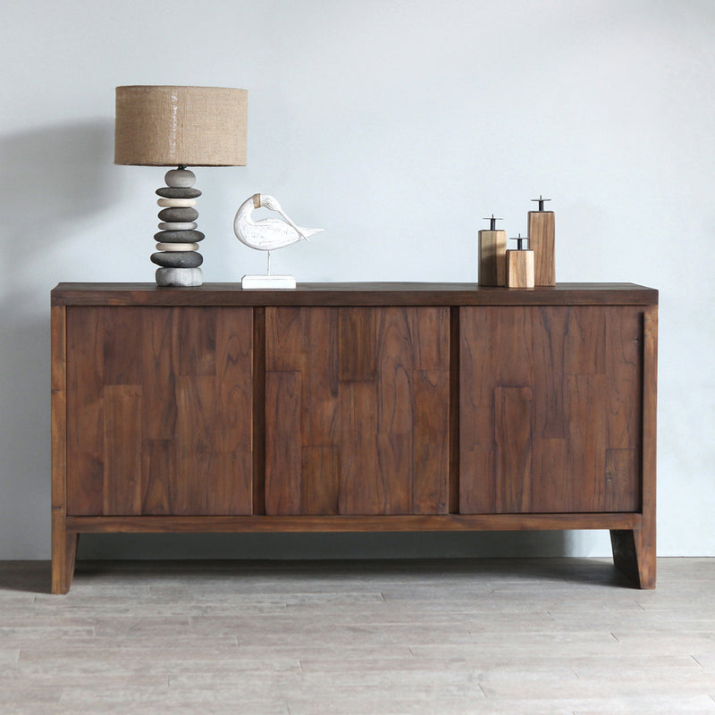 KAMA Sideboard with Pebbles Lamp and Candle Holder on top of it